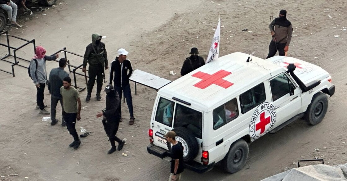 A Red Cross vehicle moves along a road before the expected release of hostages held in Gaza. Photo: Reuters