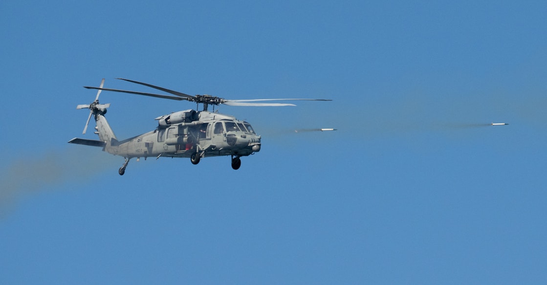 A US Navy helicopter shoots missiles during a fly-by for the US president and first lady near Norfolk, Virginia, October 5, 2025, during a Naval demonstration as part of the Navy's 250th anniversary celebration. Photo: AFP/ Saul Loeb