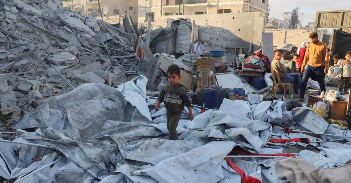 A Palestinian child walks at the site of an overnight Israeli strike on a house, in Gaza City. Photo: Reuters/Ebrahim Hajjaj