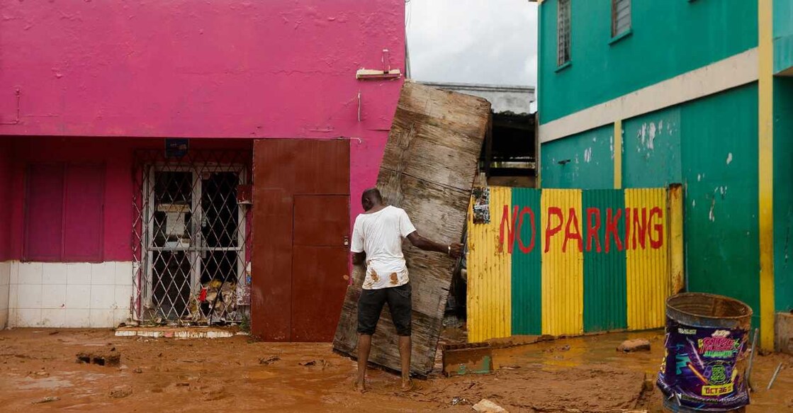 A man holds a panel that was part of a fence, after Hurricane Melissa made landfall in Jamaica. Reuters/Octavio Jones