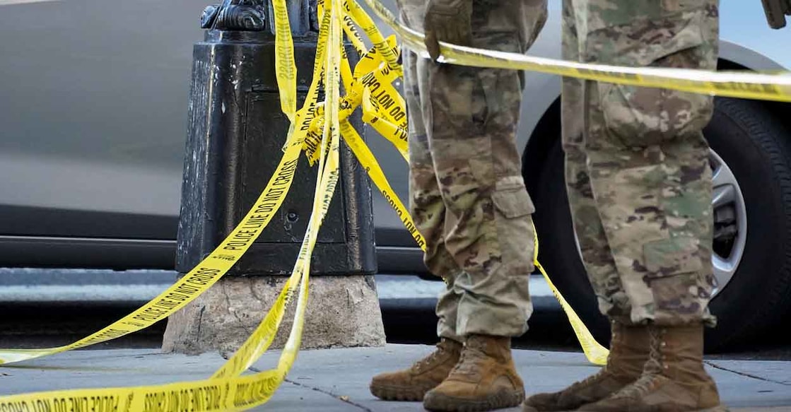 National Guard members stand together behind yellow tape, after two National Guard members were shot near the White House in Washington, DC, U.S., November 26, 2025. Photo: REUTERS/Nathan Howard
