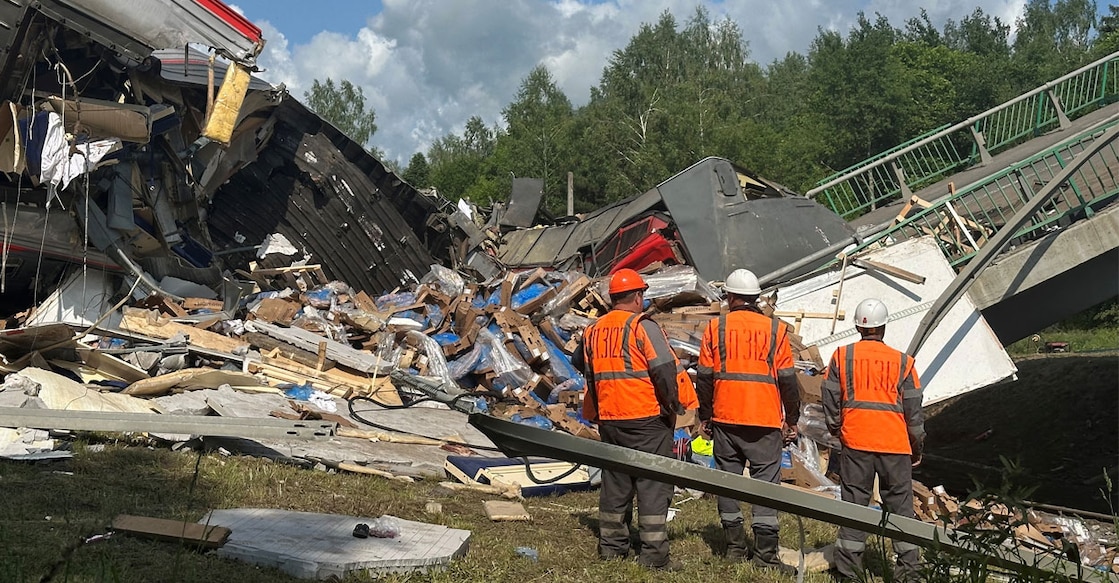 Specialists of emergency services work at the scene, after a road bridge collapsed onto railway tracks due to an explosion in the Bryansk region. Photo: Reuters
