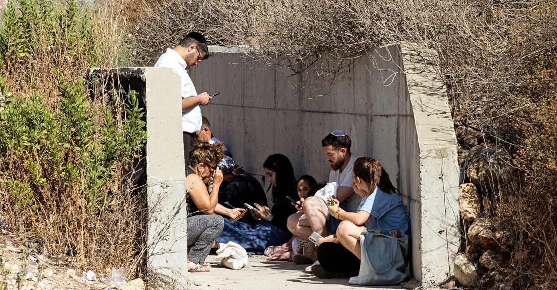Israelis take shelter at the side of a highway as siren sounds following missile attack from Iran on Israel, in central Israel on June 15. Photo: REUTERS/Oren Ben Hakoon