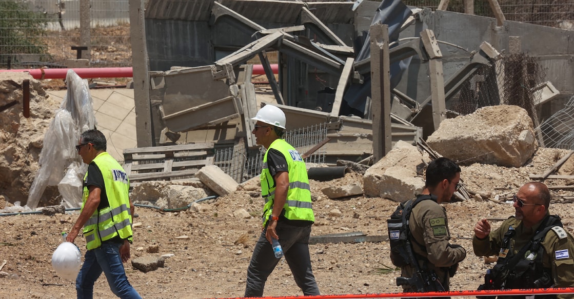 Members of Israeli security forces and emergency services work in a cordoned off area at the impact site of an Iranian rocket near the southern city of Ashdod. Photo: AFP