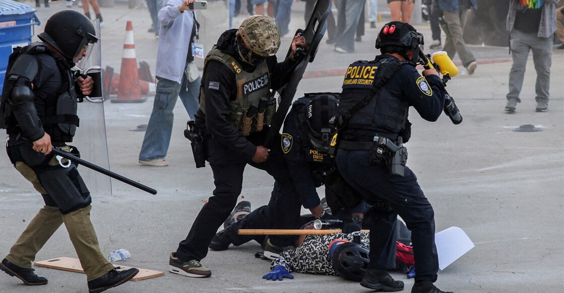 Police detains a protester blocking the garage entrance of the Los Angeles Federal Building following multiple detentions by Immigration and Customs Enforcement (ICE), in downtown Los Angeles. Photo: Reuters/Daniel Cole