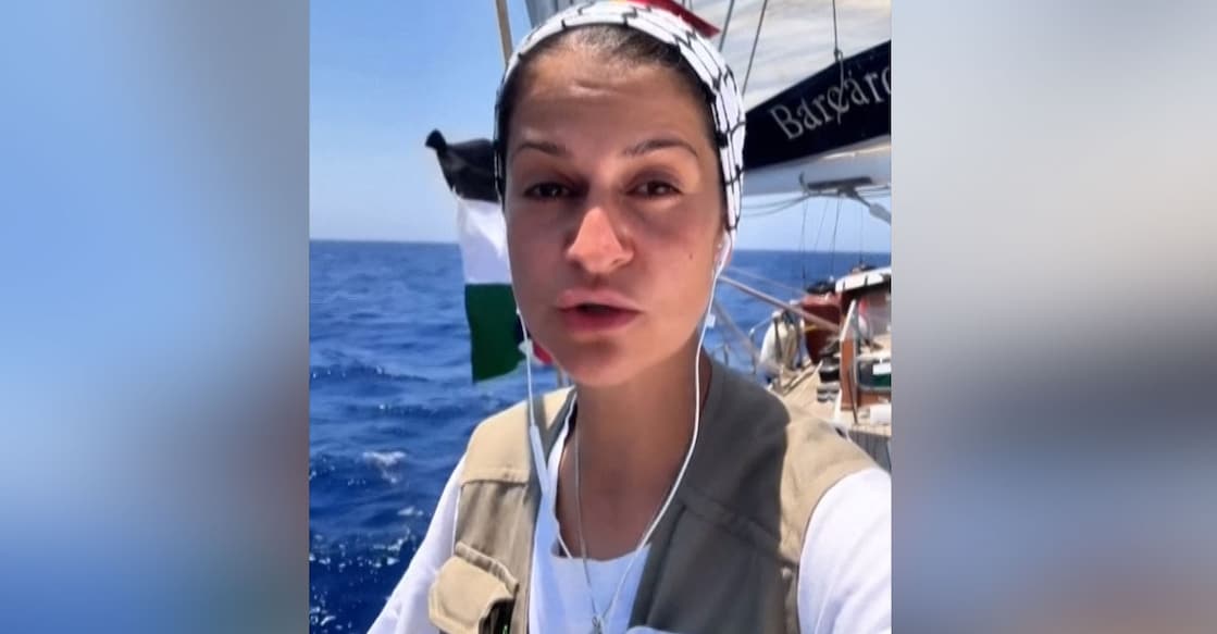 freedom-flottilla This image grab from a UGC video posted by the Freedom Flotilla Coalition on June 8, 2025, shows German human rights activist Yasemin Acar delivering a statement as the flotilla approaches the Gaza Strip. Photo: AFP