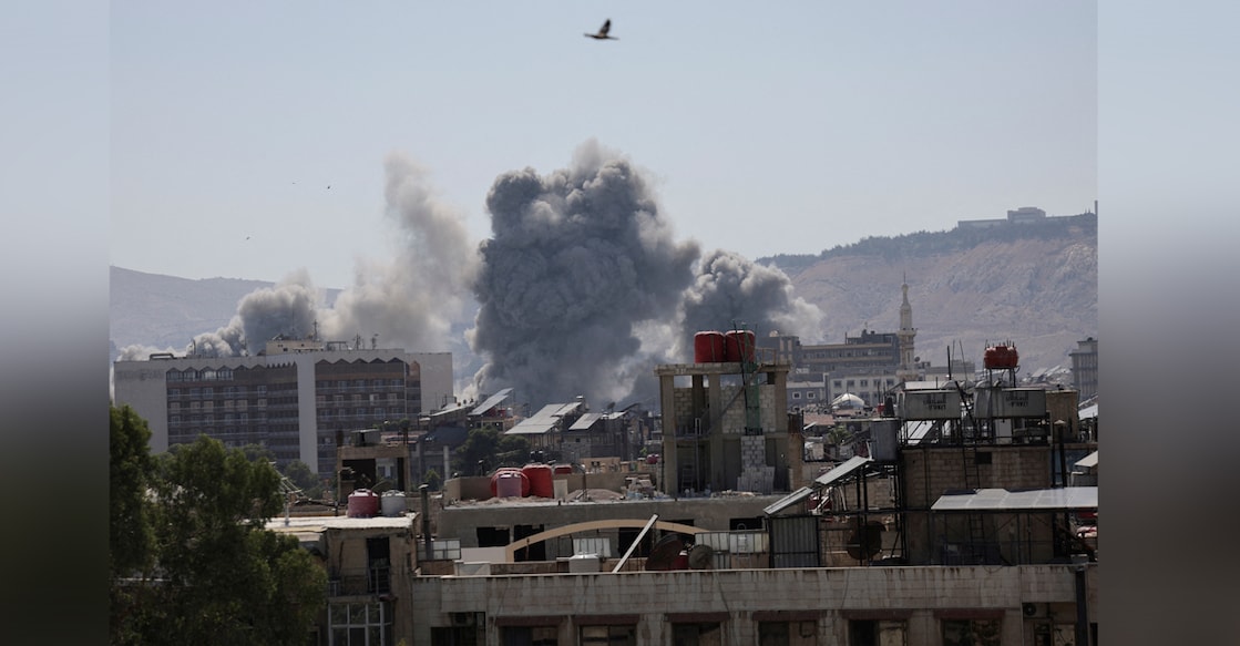 Smoke rises after strikes on Syria's defense ministry in Damascus, according to Al Jazeera TV, in Damascus, Syria July 16, 2025. Photo: REUTERS/Khalil Ashawi