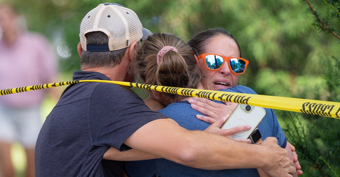 Families and loved ones reunite outside the police barricades after a shooting at Annunciation Church, which is also home to an elementary school, in Minneapolis, Minnesota, US. Photo: Reuters
