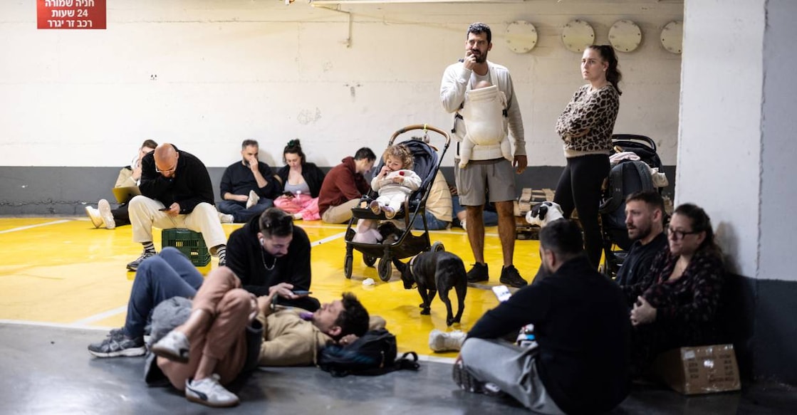 Israelis take shelter in an underground parking lot after missiles were launched towards Israel from Iran following strikes by Israel and the US on Iran. Photo: Reuters