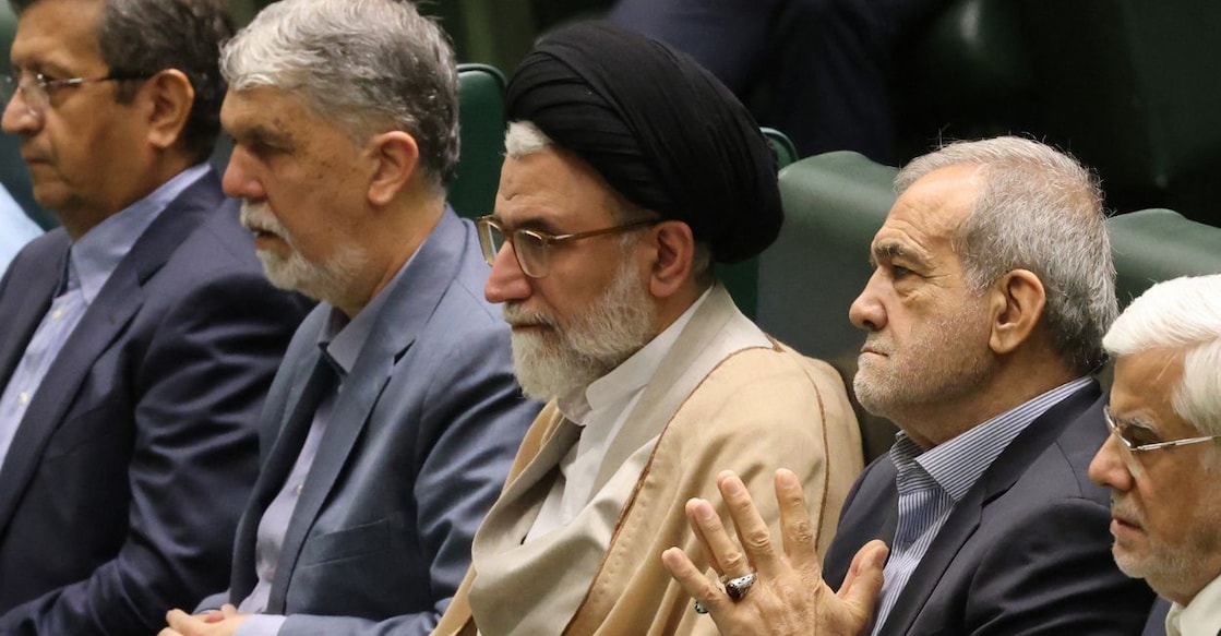 Iran's Minister of Intelligence Esmail Khatib (centre) sits with President Masoud Pezeshkian (centre-right). Photo: ATTA KENARE / AFP