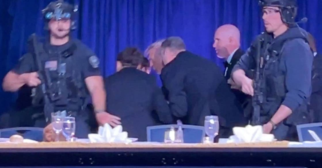 US President Donald Trump is escorted out as a shooter opens fire during the annual White House Correspondents' Association dinner in Washington, DC in this screen capture from video. REUTERS/Bo Erickson