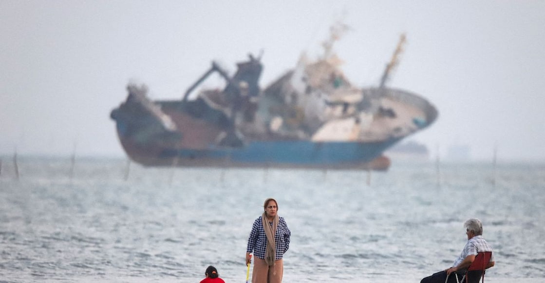 People gather on a beach, as a vessel in the Strait of Hormuz is visible, near the beach of Bandar Abbas, Iran, May 31, 2026. Photo: Amirhosein Khorgooi/ISNA/WANA (West Asia News Agency) via Reuters