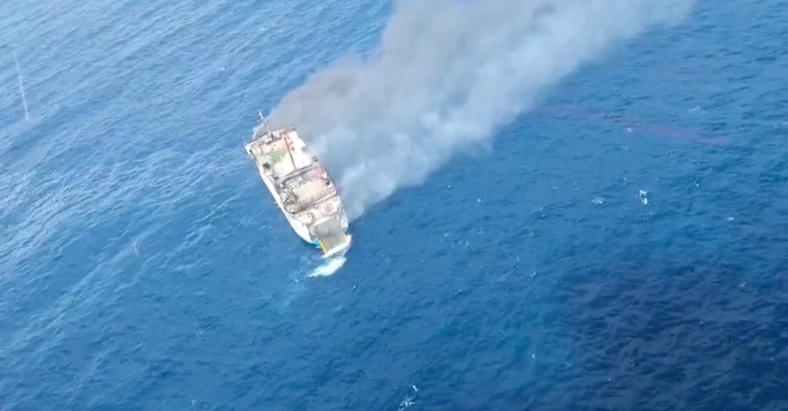 An aerial view shows thick smoke rising from KM Putri Yasmin ferry that caught fire in waters off Lombok, Indonesia on August 12, 2026. Screengrab from handout video via Reuters
