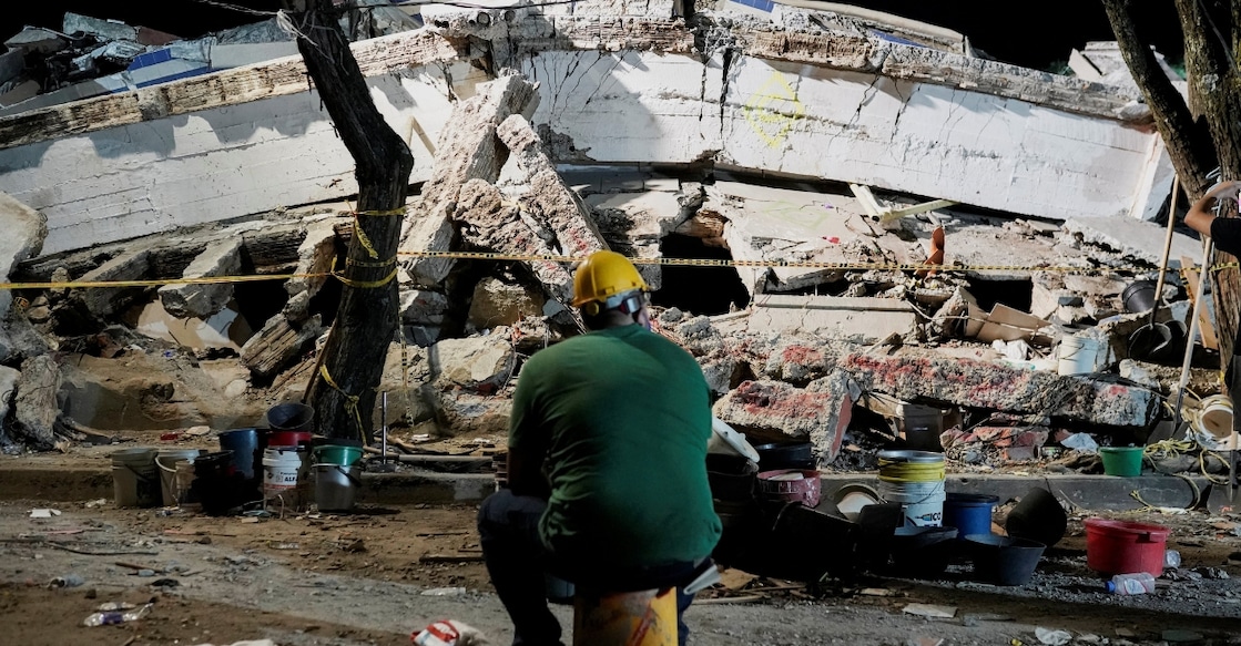 A man sits near debris at the Torres de Limonar building in the aftermath of an earthquake, in Cali, Colombia. Photo: Reuters