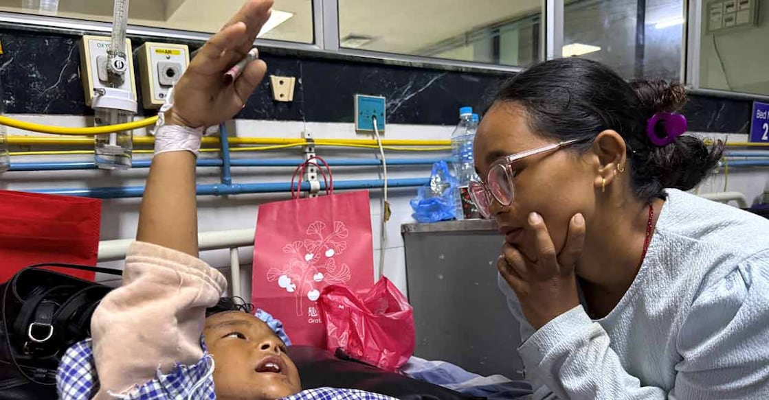 Zoyal Ghale, 8, who was airlifted from Rasuwa after being injured in the deadly flash floods and mudslide, speaks with his mother Matti Maya Tamang, 28, two days after they were separated following the floods, inside a hospital in Kathmandu, Nepal, August 28, 2026. Photo: REUTERS/Ranup Shrestha