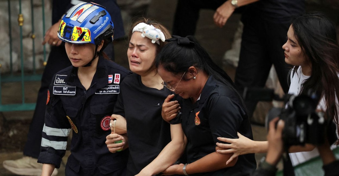 The wife of a teacher who was shot dead reacts at the Debsirin Nonthaburi School following the shooting incident. Photo: Reuters