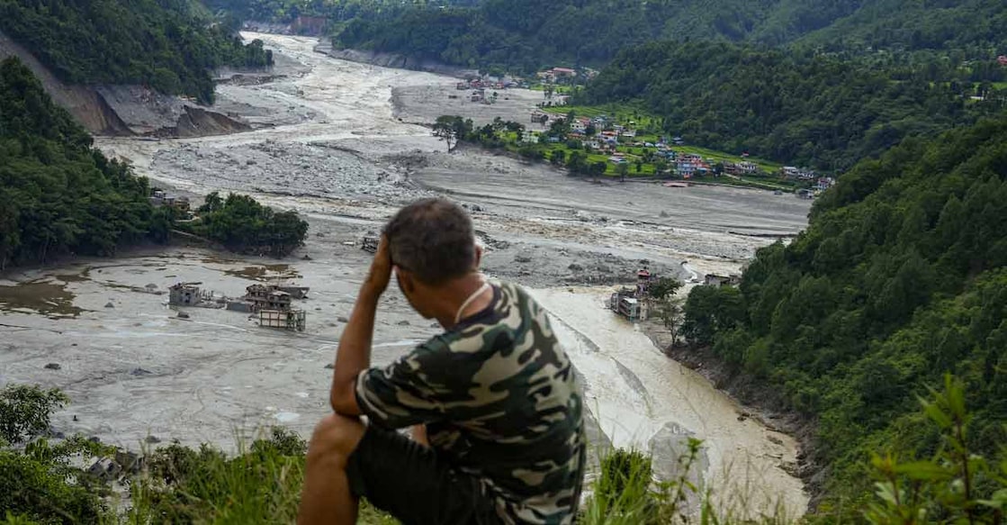 A man sits on a hilltop overlooking the flood-ravaged valley at Betrawati market, in Nuwakot district, Nepal, Wednesday, Sept. 2, 2026. Photo: PTI /Arun Sharma