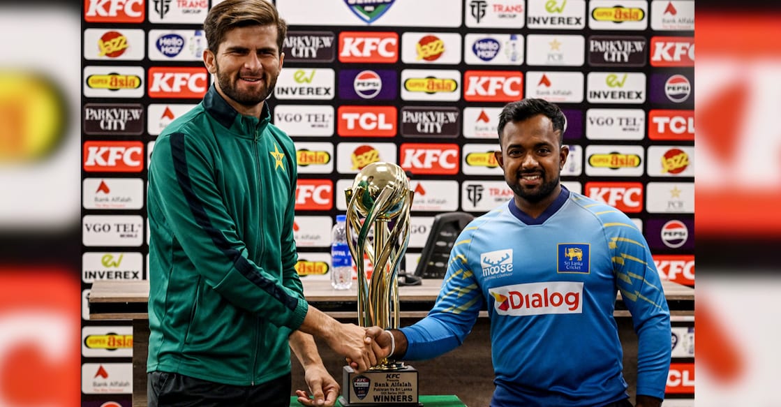 Pakistan's captain Shaheen Shah Afridi (left) and his Sri Lankan counterpart Charith Asalanka shake hands as they pose with the series trophy on the eve of their ODI match at the Rawalpindi Cricket Stadium in Rawalpindi on November 10, 2025. Photo: AFP/ Aamir Qureshi 