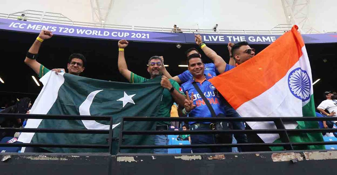 Cricket - ICC Men's T20 World Cup 2021 - Super 12 - Group 2 - India v Pakistan - Dubai International Stadium, Dubai, United Arab Emirates - October 24, 2021 India and Pakistan fans display their flags in the stand before the match REUTERS/Satish Kumar