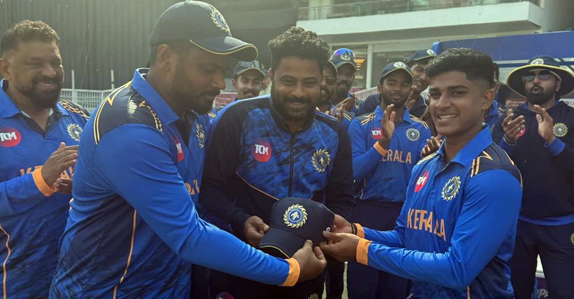 Vignesh Puthur receives his maiden Kerala cap from captain Sanju Samson in the presence of Prasanth Padmanabhan, chairman of the KCA selection committee. Photo: KCA