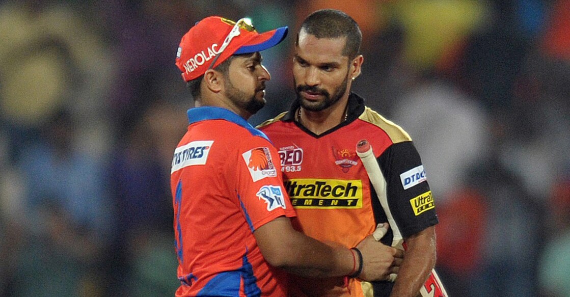 In this file photo from May 2016, Gujarat Lions captain Suresh Raina (left) greets Sunrisers Hyderabad batsman Shikhar Dhawan after an IPL match at the Rajiv Gandhi International Stadium in Hyderabad. File photo: AFP/ Noah Seelam 