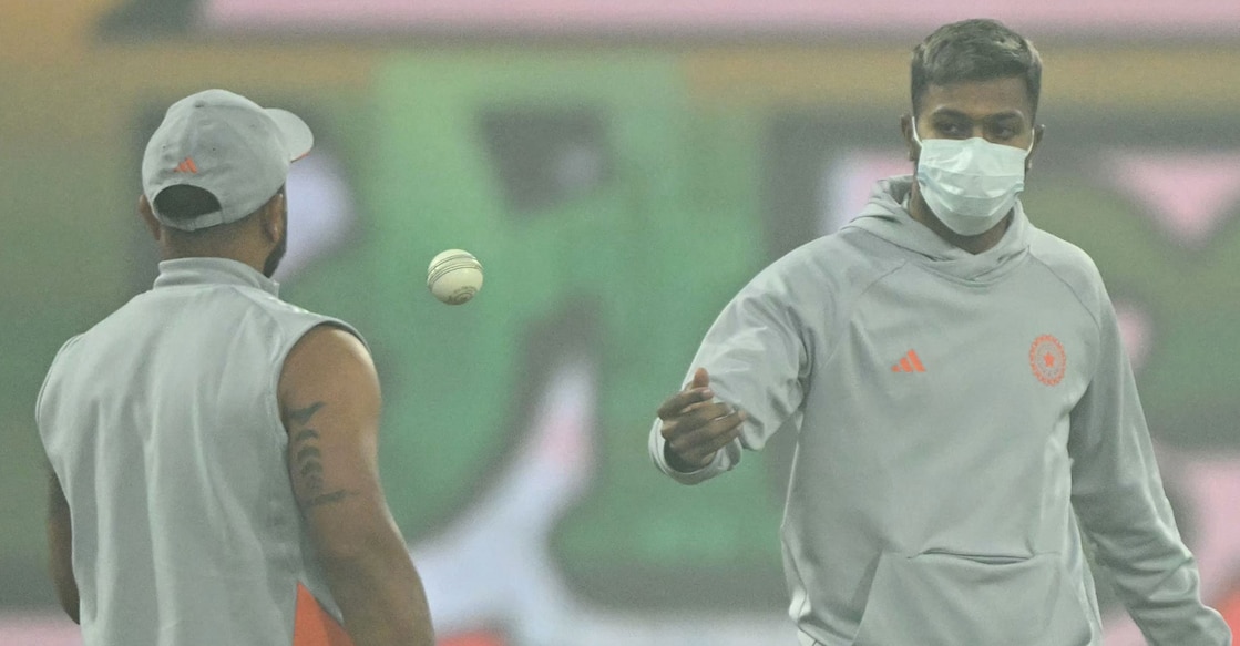 India's Hardik Pandya wears a mask as he warms up before the fourth T20I against South Africa at the Ekana Cricket Stadium in Lucknow on December 17, 2025. Photo: AFP/ Sajjad Hussain