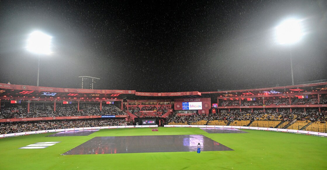 A general view of covers on the pitch as rain delays the start of the Indian Premier League (IPL) Twenty20 cricket match between Royal Challengers Bengaluru and Kolkata Knight Riders at the M Chinnaswamy Stadium in Bengaluru on May 17, 2025. File photo: AFP/