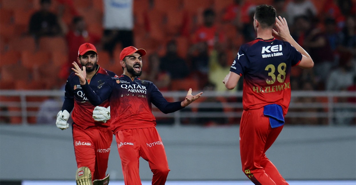 rcb-celebration Royal Challengers Bengaluru's Josh Hazlewood celebrates with Virat Kohli after taking the wicket of Punjab Kings' Shreyas Iyer. Photo: Reuters/Anushree Fadnavis