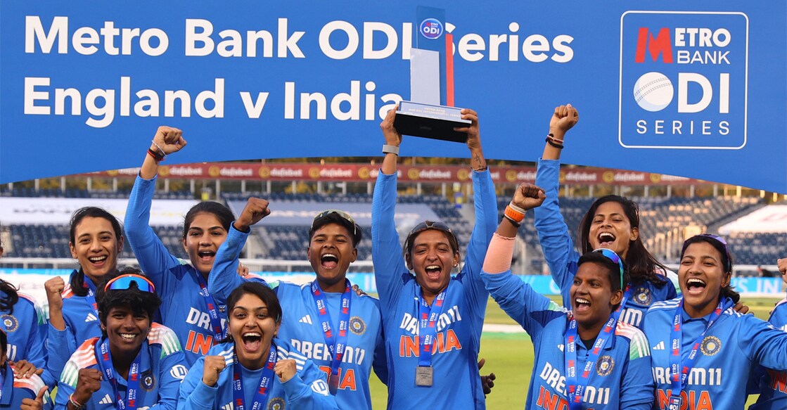 India's Harmanpreet Kaur lifts the trophy as she celebrates with teammates after winning the Women's One Day International series against England. Photo: Reuters/Ed Sykes
