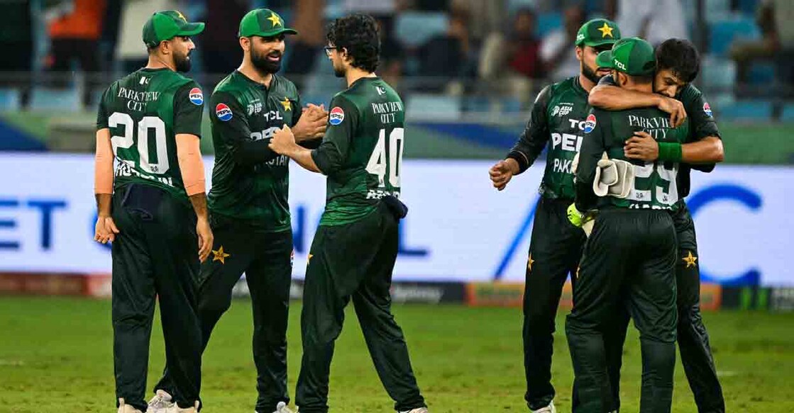 TOPSHOT - Pakistan's players celebrate after defeating Bangladesh in the Asia Cup 2025 Super Four Twenty20 international cricket match between Bangladesh and Pakistan at the Dubai International Stadium in Dubai on September 25, 2025. (Photo by Sajjad HUSSAIN / AFP)