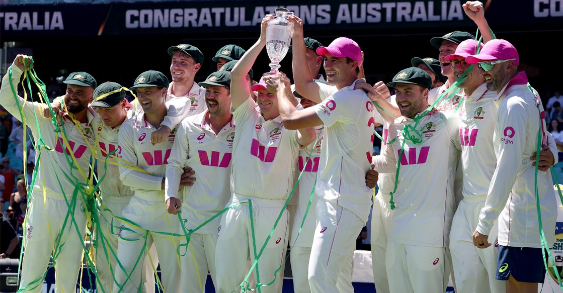 The Australian cricket team celebrating with the Ashes trophy. Photo: AFP