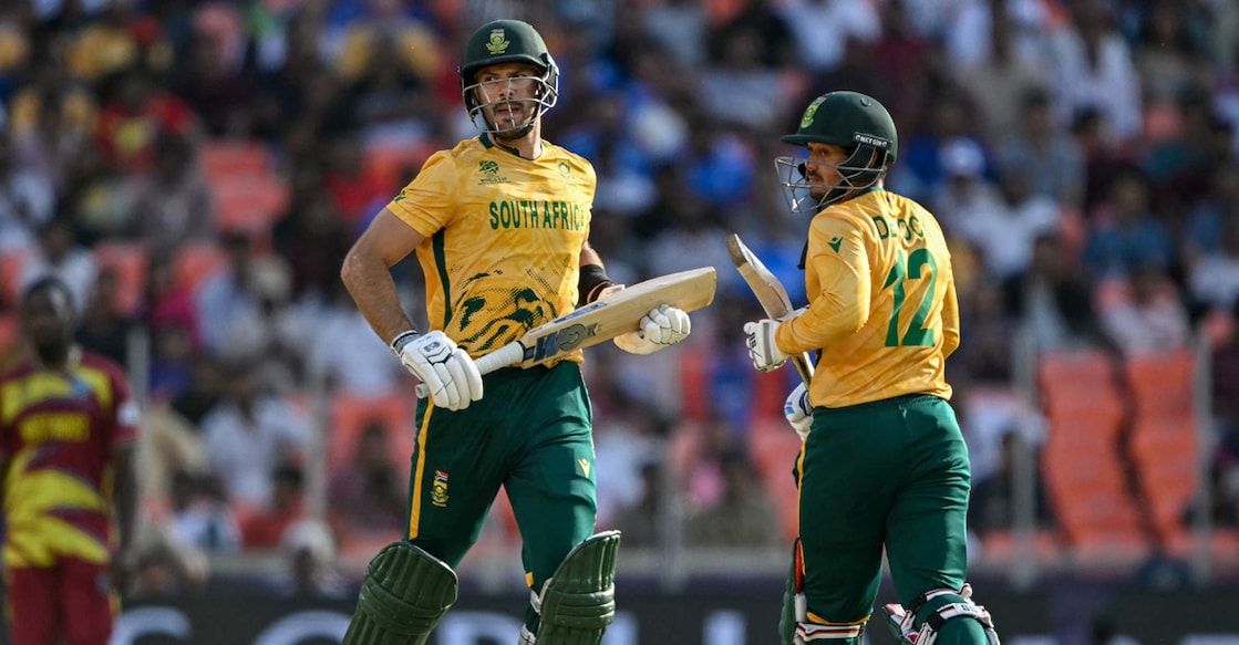 South Africa's captain Aiden Markram and Quinton de Kock run between the wickets during the 2026 ICC Men's T20 Cricket World Cup Super Eights match against West Indies in Ahmedabad on February 26, 2026. Photo: AFP/Indranil Mukherjee 