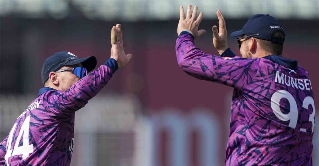 Scotland's captain Richie Berrington celebrates with teammate George Munsey after beating Italy at Eden Gardens in Kolkata on Monday. Photo: PTI/Swapan Mahapatra
