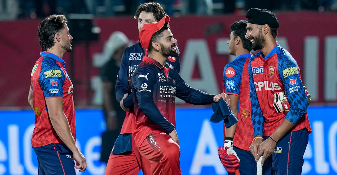 Royal Challengers Bengaluru's Virat Kohli interacts with Punjab Kings' Harpreet Brar after an IPL 2026 match in Dharamshala on May 17, 2026. Photo: PTI