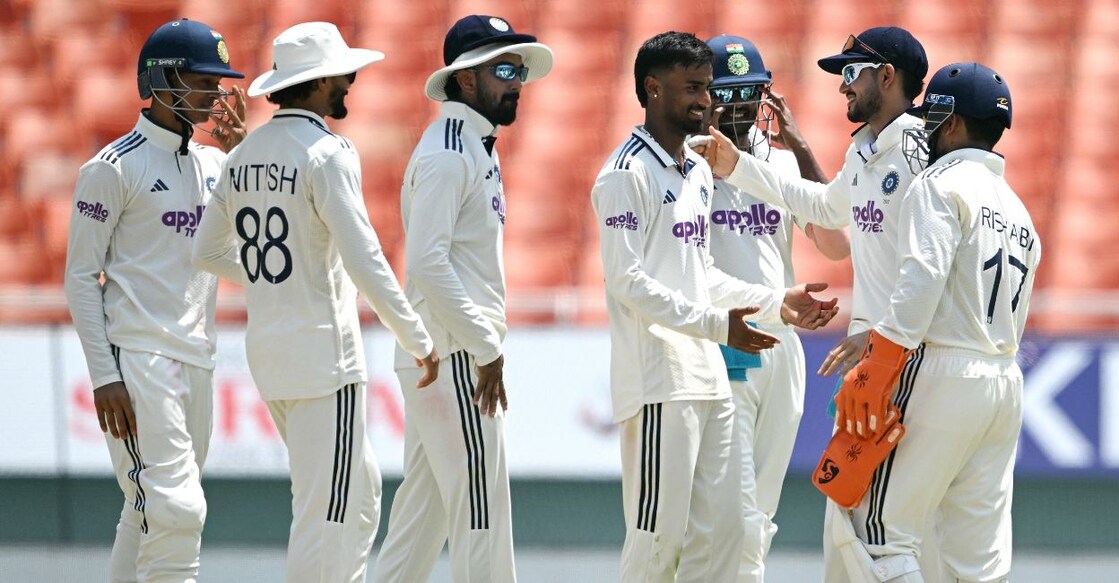 India's Manav Suthar (C) celebrates with teammates after taking the wicket of Afghanistan's Rahmat Shah during the third day of the only Test cricket match. Photo: AFP
