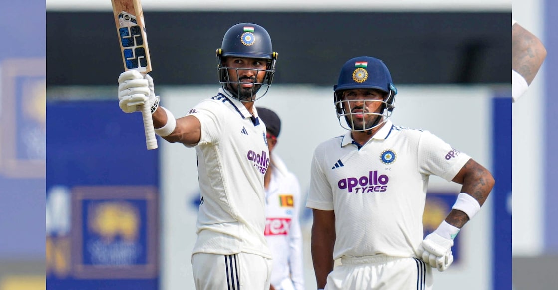 India's Devdutt Padikkal (L) celebrates his one hundred and fifty runs on day two of the first test cricket match between India and Sri Lanka. Photo: PTI