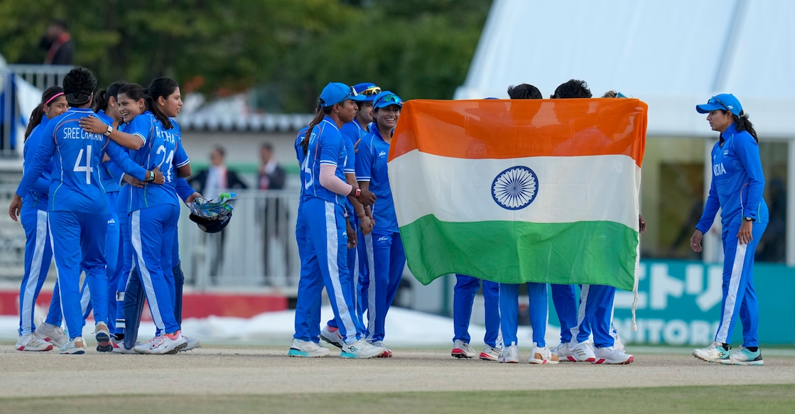 Nagoya: India's players hold the national flag after winning in the women's final T20I cricket match between India and Sri Lanka in the ongoing Asian Games 2026, in Nagoya, Japan, Tuesday, Sept. 22, 2026. They secured first gold medal of the 2026 Asian Games, defeating Sri Lanka by 147 runs in the women's cricket final.(PTI Photo/Arun Sharma)(PTI09_22_2026_000160B) *** Local Caption *** 