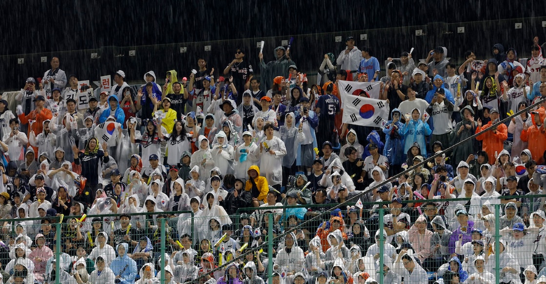 Asian Games - Aichi-Nagoya 2026 - Baseball - Gold Medal Match - South Korea v Japan - Toyohashi Municipal Baseball Stadium, Toyohashi, Japan - September 27, 2026  Fans wear rain ponchos in the stands REUTERS/Eloisa Lopez