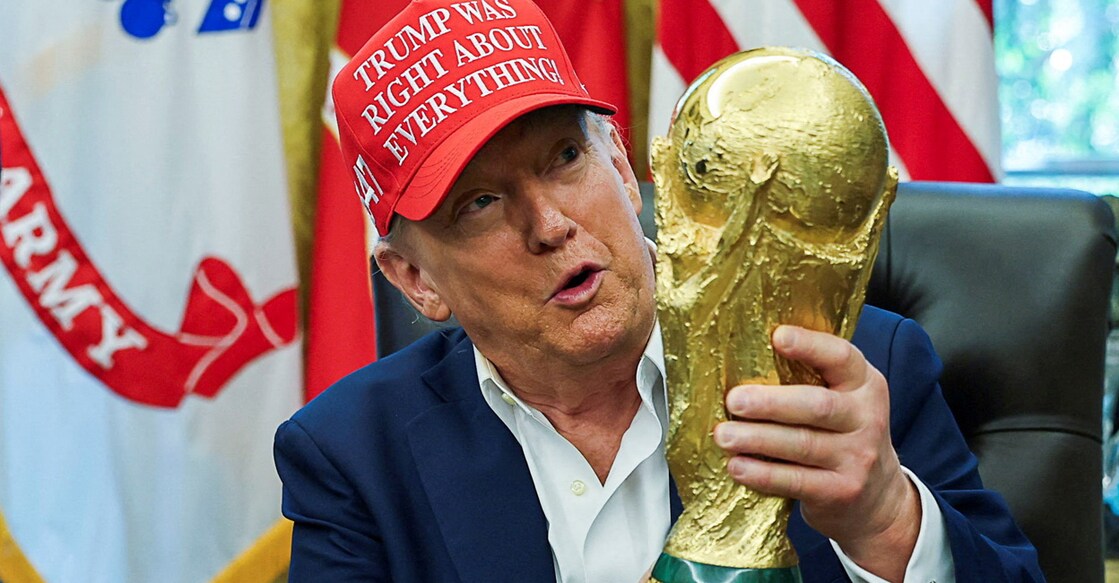 US President Donald Trump wears a 'Trump Was Right About Everything!' hat while holding the FIFA World Cup Trophy, as he makes an announcement on the 2026 FIFA World Cup, in the Oval Office at the White House in Washington on August 22, 2025. Photo: Reuters/Jonathan Ernst