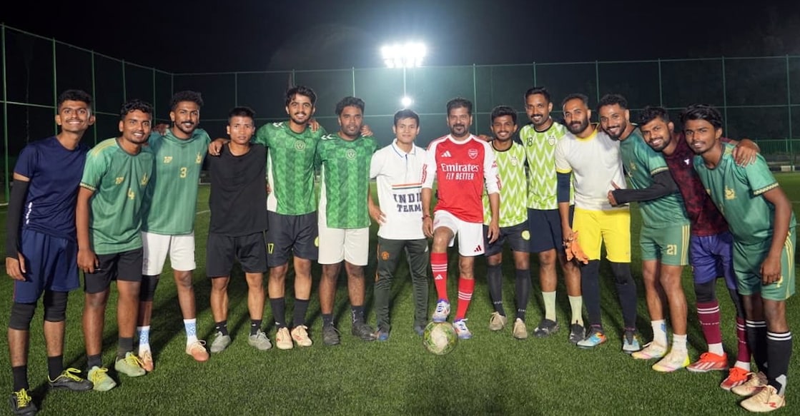 Telangana Chief Minister Revanth Reddy poses for a photo with youngsters after a practice match on a turf in Hyderabad. Credit: To the respective owner