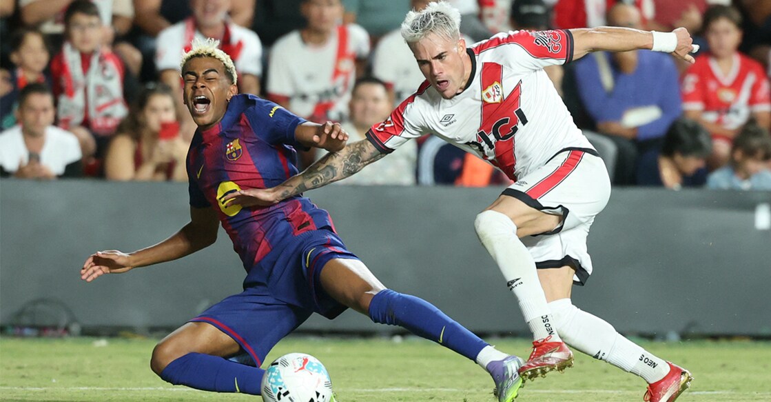Barcelona's Lamine Yamal fights for the ball with Rayo Vallecano's Pep Chavarria during the Spanish league football match. Photo: AFP