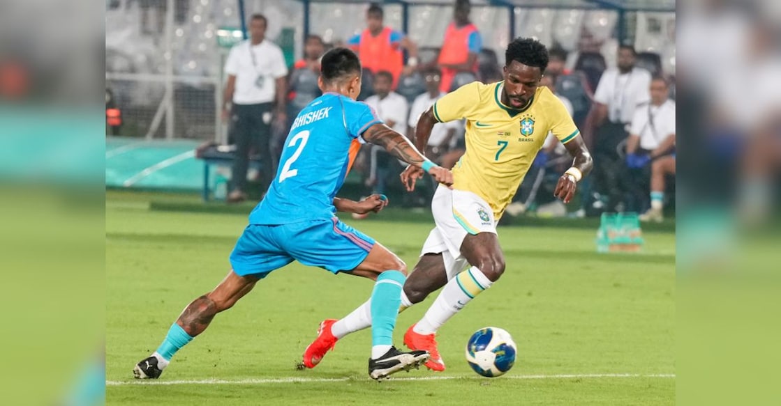India's Abhishek Singh Tekcham, blue, and Brazil's Vinicius Junior vie for the ball during an International friendly Football match between India and Brazil, in Kolkata, Saturday, Oct. 3, 2026. Photo: PTI. 