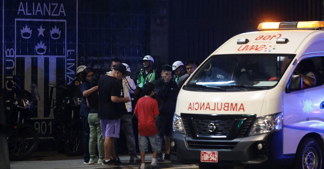 Relatives wait for news at the entrance of the Alejandro Villanueva Stadium after an accident in the stands where Alianza Lima's fans were cheering for their team on the eve of the match against Universitario in Lima. Photo: AFP