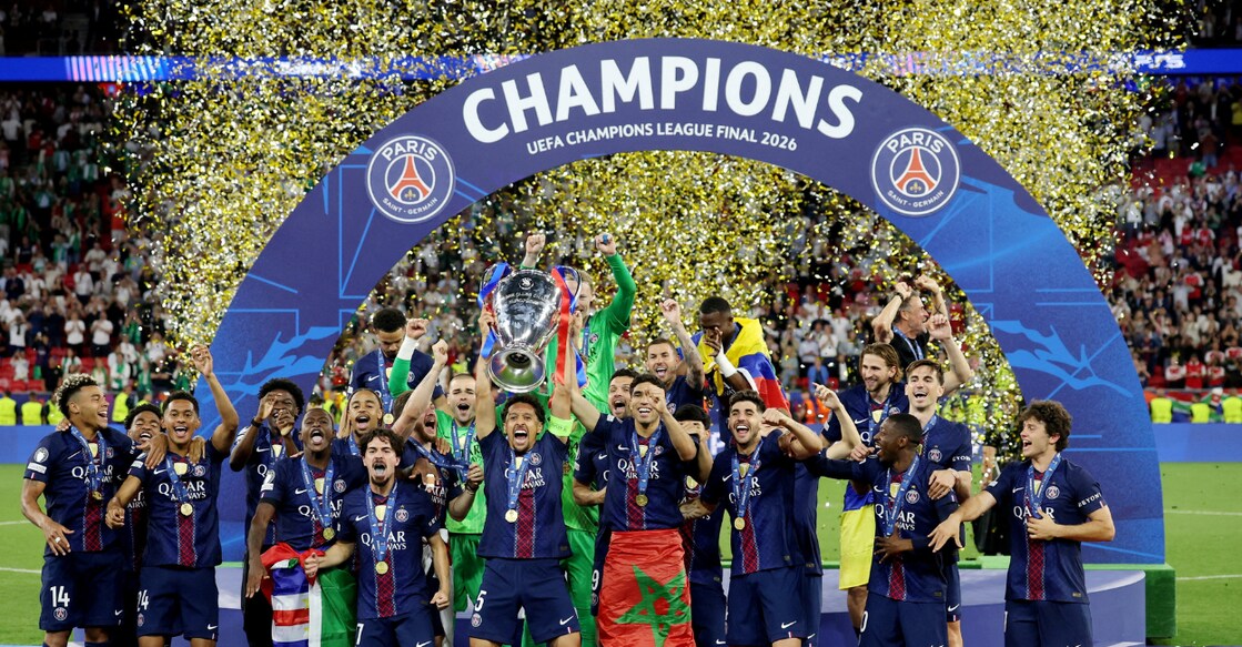Paris St Germain's Marquinhos lifts the trophy as he celebrates with teammates after winning the UEFA Champions League. Photo: Reuters.