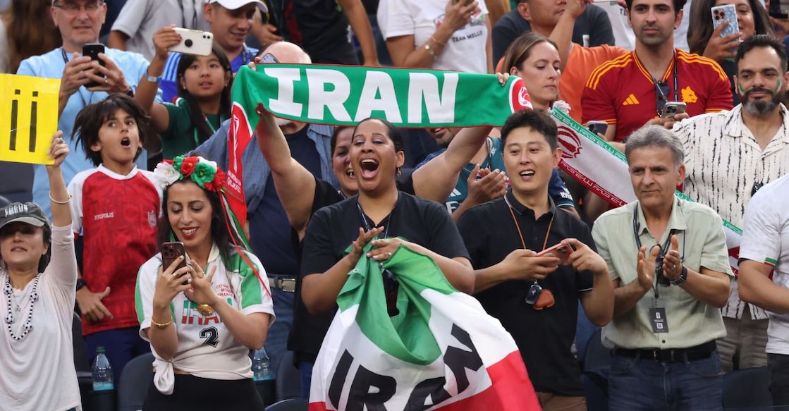 Iran fans celebrate after Ramin Rezaeian scores their first goal against New Zealand. Photo: Reuters