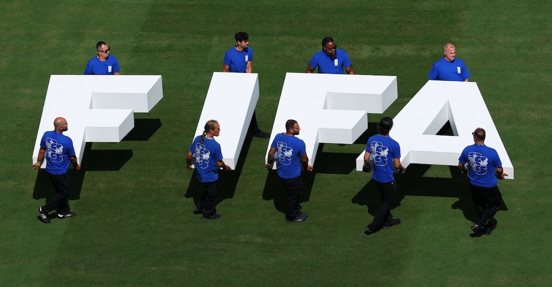 Pitch staff carry the FIFA logo on the pitch before the World Cup final match between Argentina and Spain. Photo: Reuters