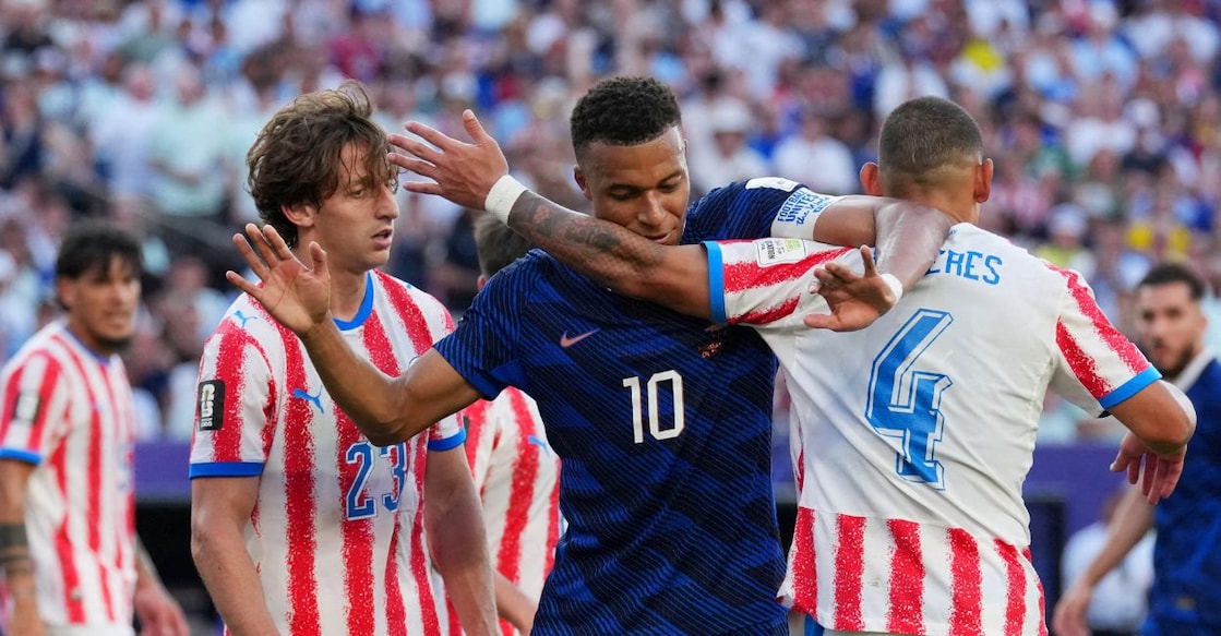 France's Kylian Mbappe reacts with Paraguay's Juan Jose Caceres Photo: IMAGN IMAGES via Reuters/James Lang