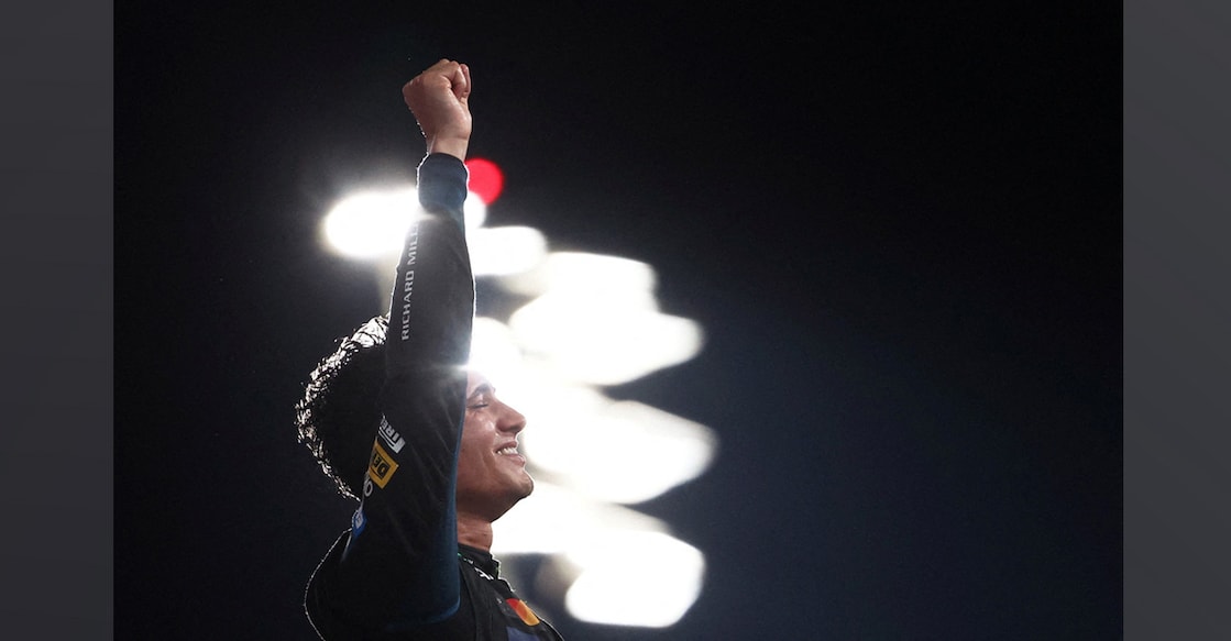 McLaren's Lando Norris celebrates on the podium after becoming the 2025 Formula One World Champion. Photo: Reuters/Jakub Porzycki
