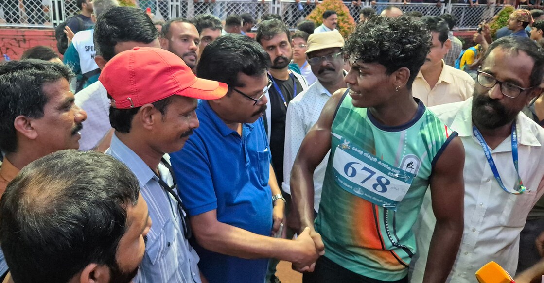 Ram Kumar (blue) shakes hands with Athul T M after the Junior Boys' 100 m final of the Kerala State School Sports meet at the Chandrasekharan Nair Stadium in Thiruvananthapuram on October 23, 2025. Photo: Arun George/Onmanorama