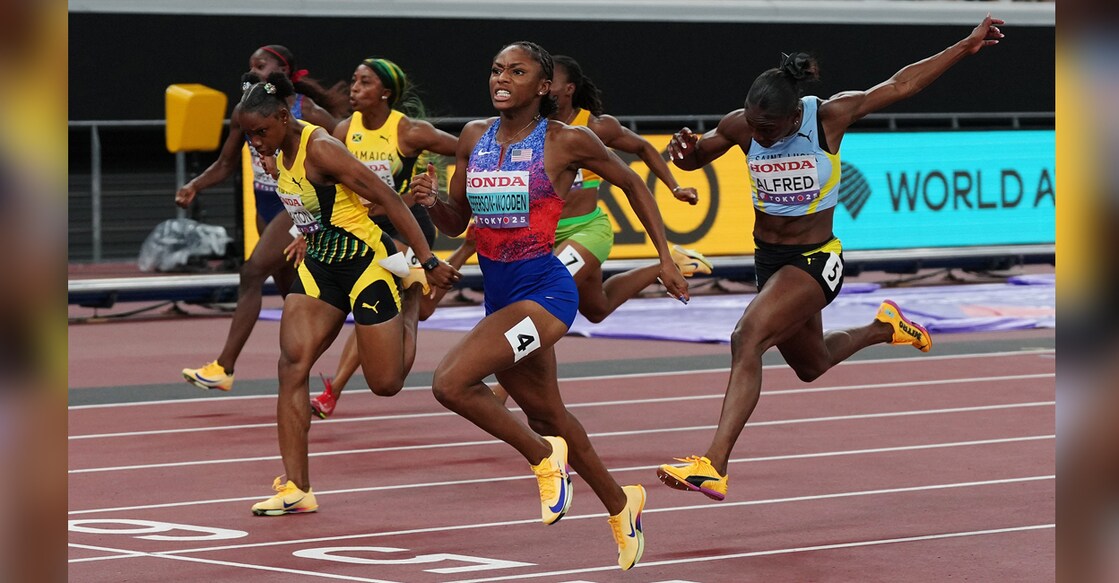 Melissa Jefferson-Wooden of the US crosses the line to win the final ahead of third placed Saint Lucia's Julien Alfred. Photo: Reuters/Aleksandra Szmigiel